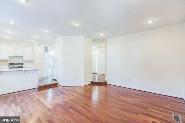 unfurnished living room with hardwood / wood-style flooring