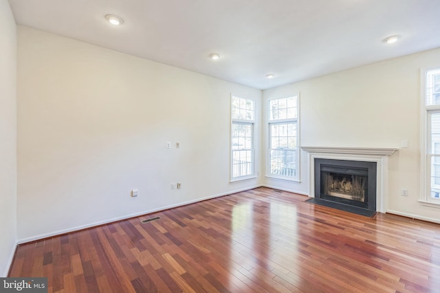 unfurnished living room featuring wood-type flooring