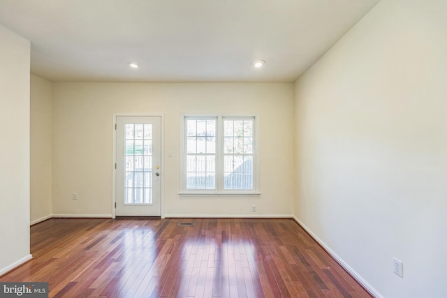 doorway with dark wood-type flooring