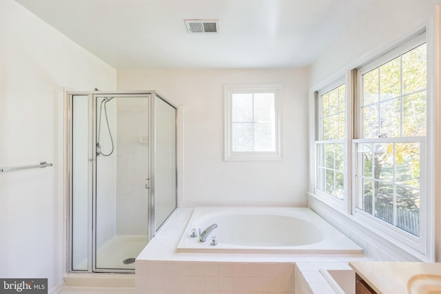 bathroom featuring vanity and plus walk in shower