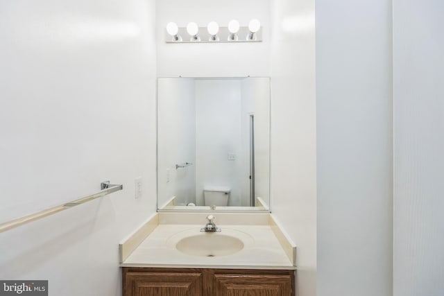 bathroom featuring vanity and toilet