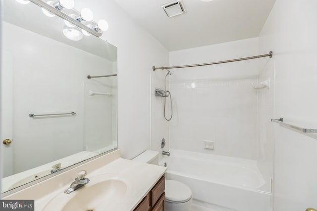 full bathroom featuring tiled shower / bath, vanity, and toilet