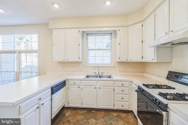 kitchen featuring white cabinetry, kitchen peninsula, white appliances, and plenty of natural light