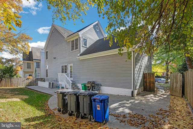 rear view of house featuring a patio and central AC