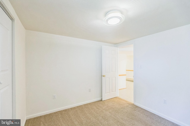 unfurnished room with light colored carpet