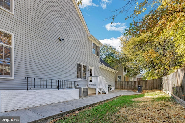 exterior space with central AC, a patio, and a wooden deck