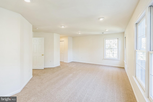 unfurnished room with light carpet