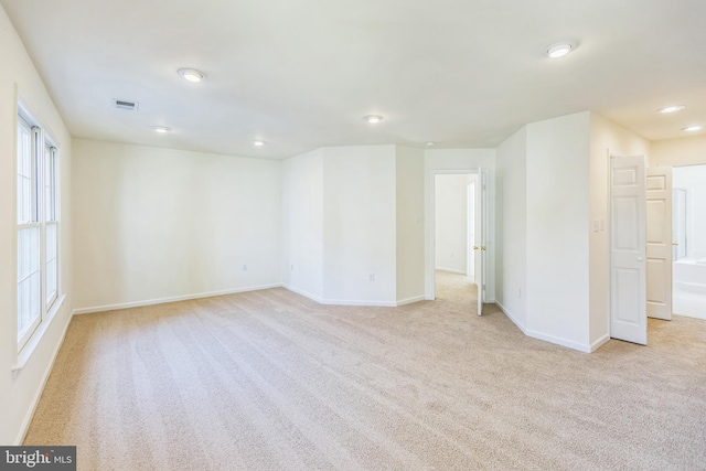 carpeted empty room with plenty of natural light