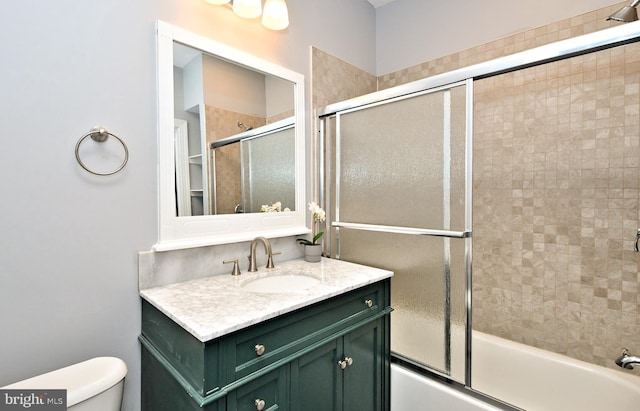 full bathroom featuring bath / shower combo with glass door, toilet, and vanity