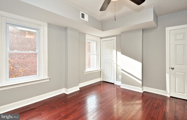 unfurnished room featuring wood-type flooring, baseboards, a ceiling fan, and plenty of natural light