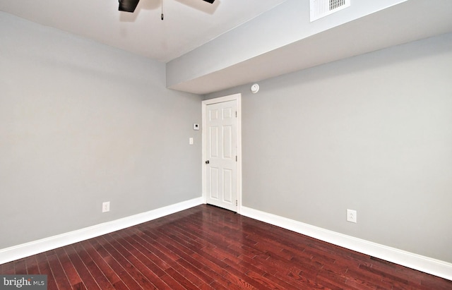 empty room featuring wood finished floors, baseboards, and a ceiling fan