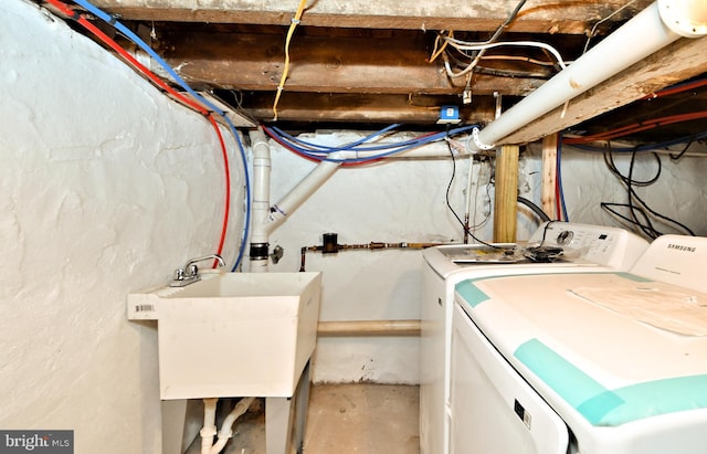 unfinished basement with independent washer and dryer and a sink