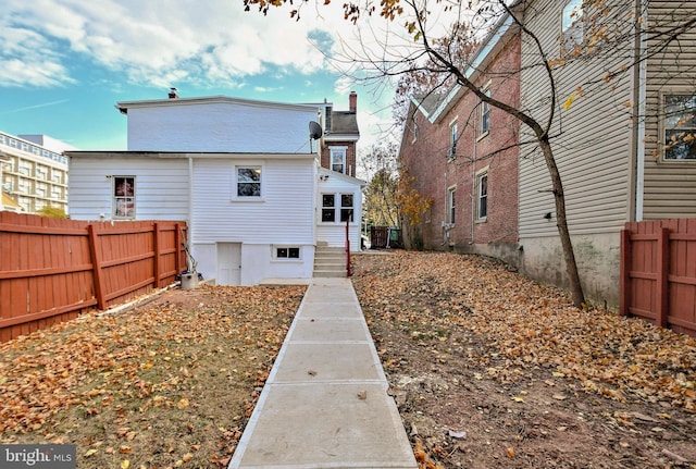rear view of house featuring fence