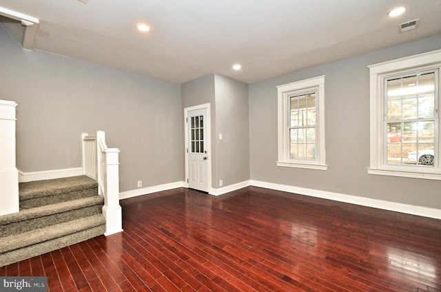 below grade area featuring dark wood-style flooring, baseboards, stairway, and recessed lighting