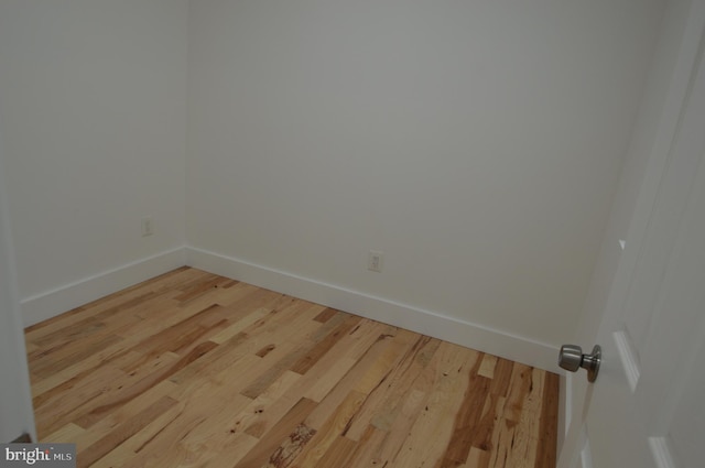 unfurnished room with hardwood / wood-style flooring