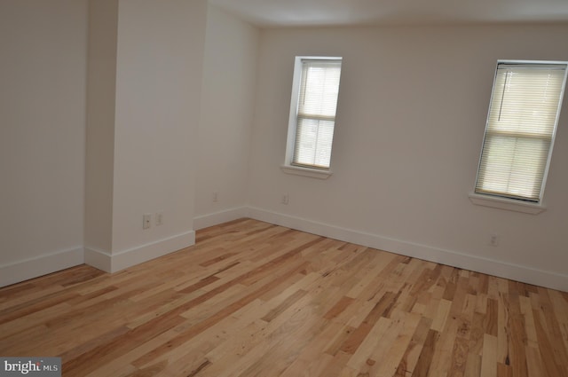 unfurnished room with light hardwood / wood-style flooring