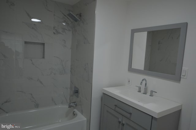 bathroom featuring vanity and tiled shower / bath