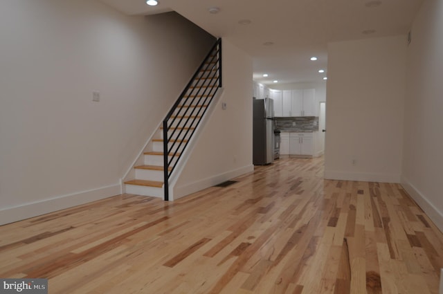 unfurnished living room with light wood-type flooring