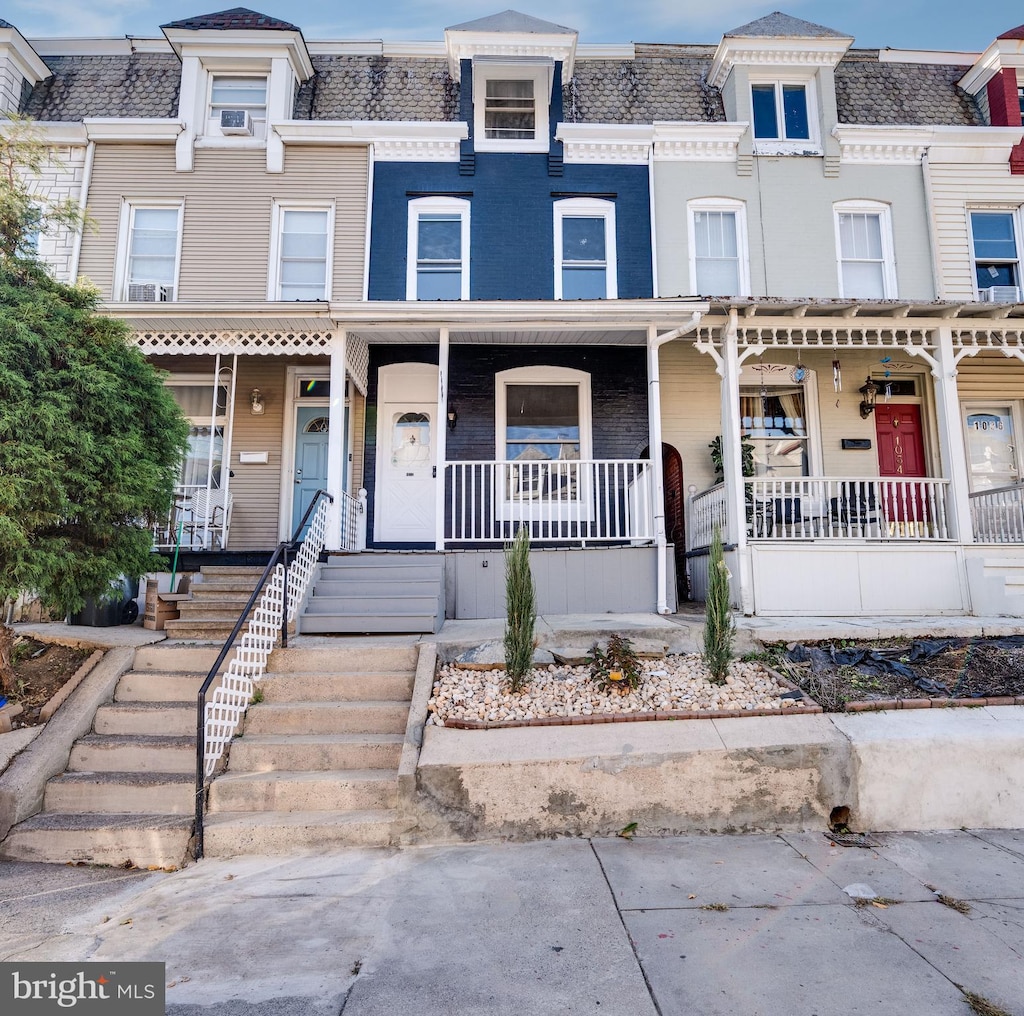 townhome / multi-family property featuring a porch