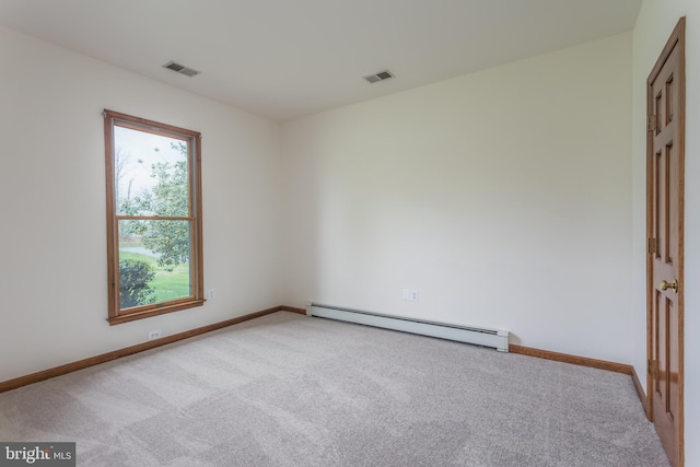 spare room with light carpet and baseboard heating