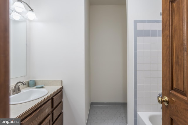 bathroom with vanity, tiled shower / bath combo, and tile patterned floors