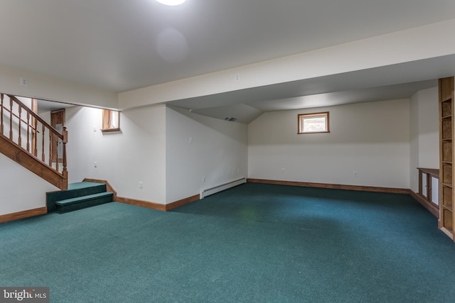 basement featuring baseboard heating and dark colored carpet