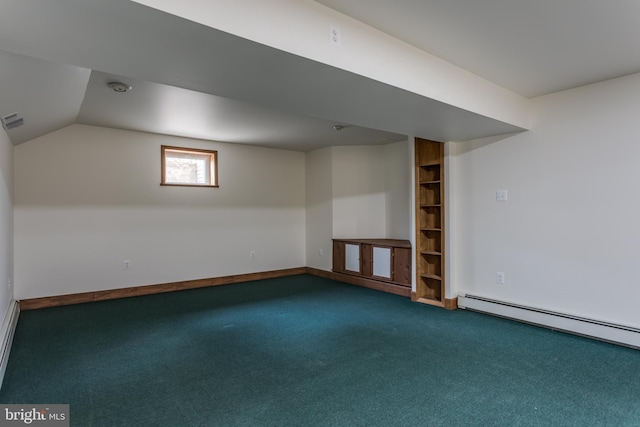 basement featuring dark carpet and a baseboard heating unit