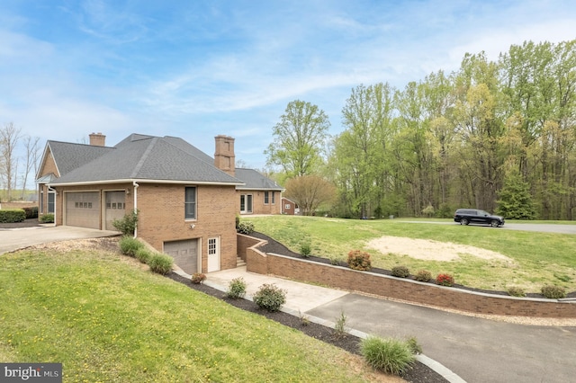 view of home's exterior with a lawn and a garage