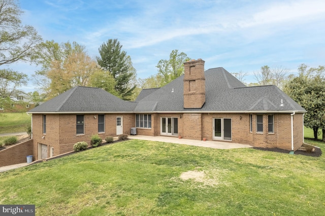 back of house with a yard and a patio