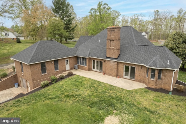 rear view of property featuring a yard, a patio, and central air condition unit