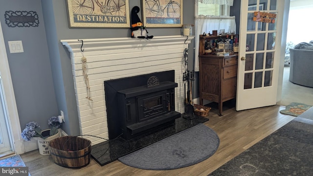 details with hardwood / wood-style flooring and a wood stove