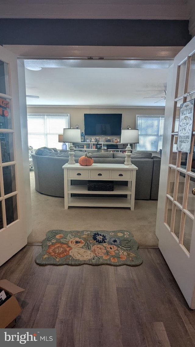 living room featuring hardwood / wood-style floors, plenty of natural light, and beam ceiling