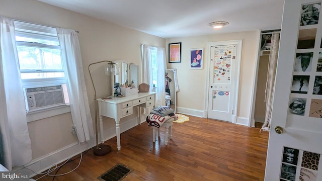 foyer entrance with cooling unit and wood-type flooring