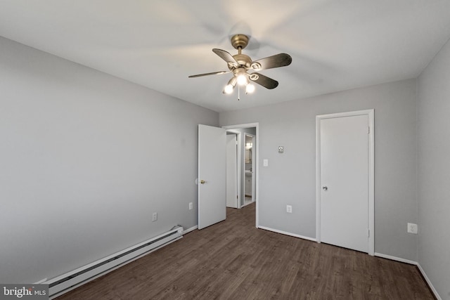 unfurnished bedroom featuring dark hardwood / wood-style flooring, baseboard heating, and ceiling fan