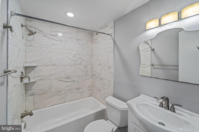 full bathroom with vanity, toilet, and tiled shower / bath combo