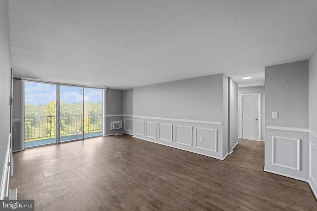 empty room with dark hardwood / wood-style flooring