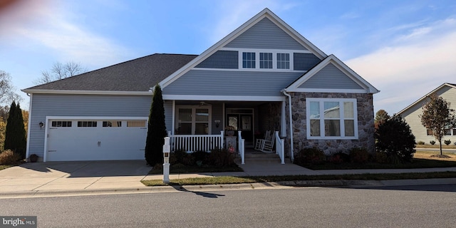 view of front of property with a porch and a garage