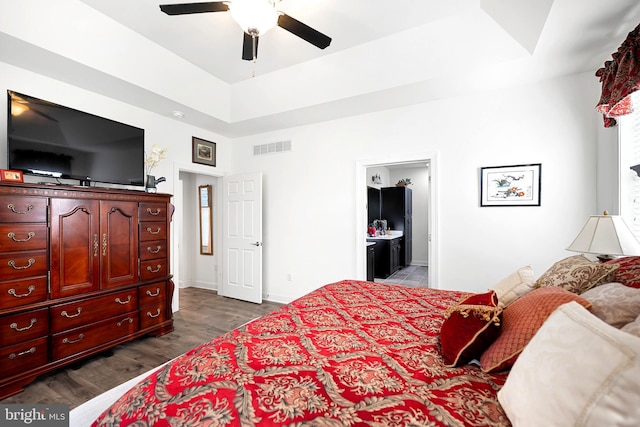 bedroom featuring hardwood / wood-style flooring, ceiling fan, and ensuite bathroom