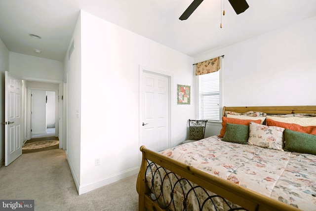 bedroom featuring light carpet and ceiling fan