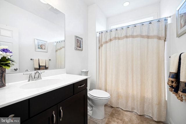 bathroom featuring tile patterned flooring, vanity, and toilet