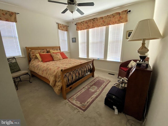 bedroom with ceiling fan and light colored carpet