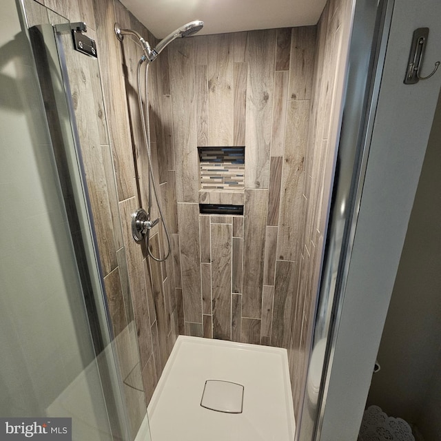 bathroom with tiled shower