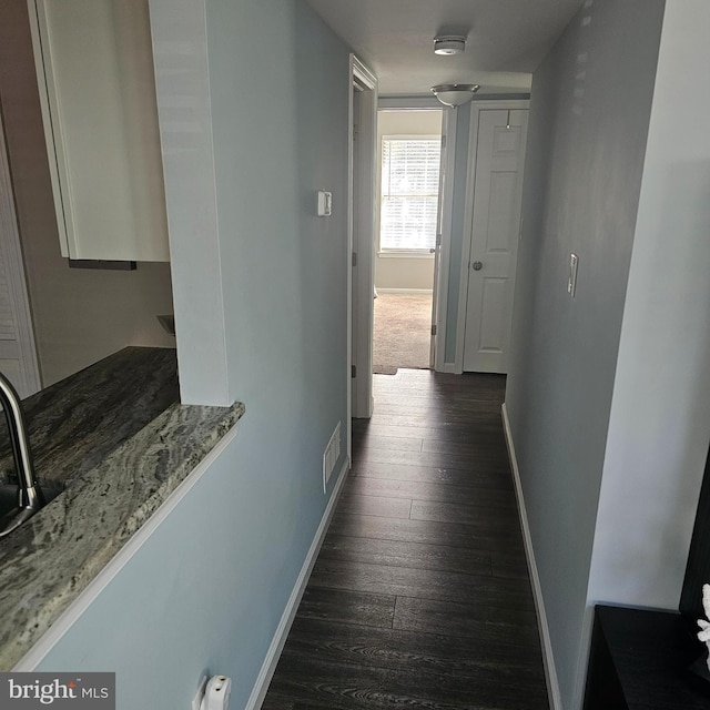 hallway with dark wood-type flooring