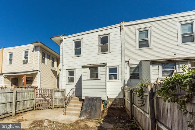 back of house featuring cooling unit