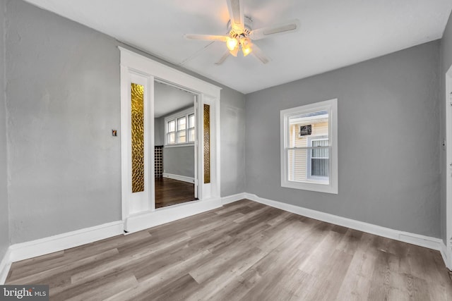 empty room featuring hardwood / wood-style floors and ceiling fan