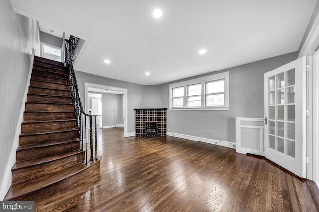 unfurnished living room featuring dark hardwood / wood-style floors and radiator