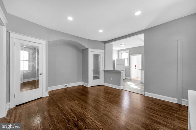 unfurnished living room with hardwood / wood-style flooring