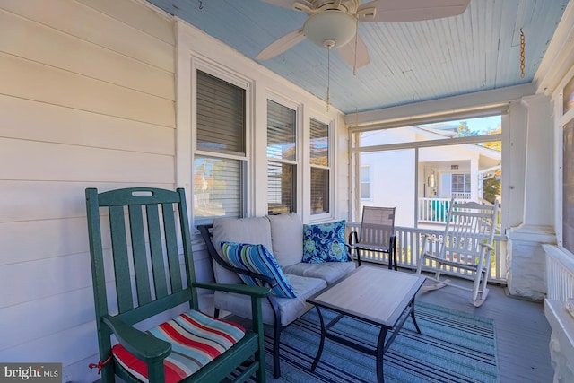 sunroom featuring ceiling fan