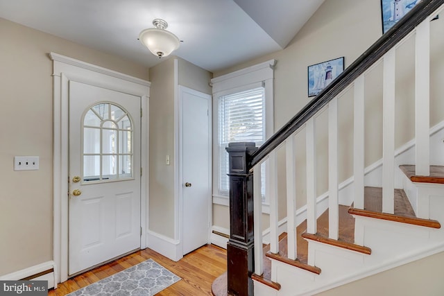 entrance foyer with a baseboard radiator and light hardwood / wood-style floors