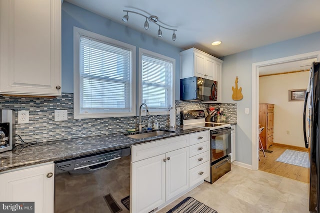 kitchen featuring white cabinetry, dark stone counters, sink, and black appliances